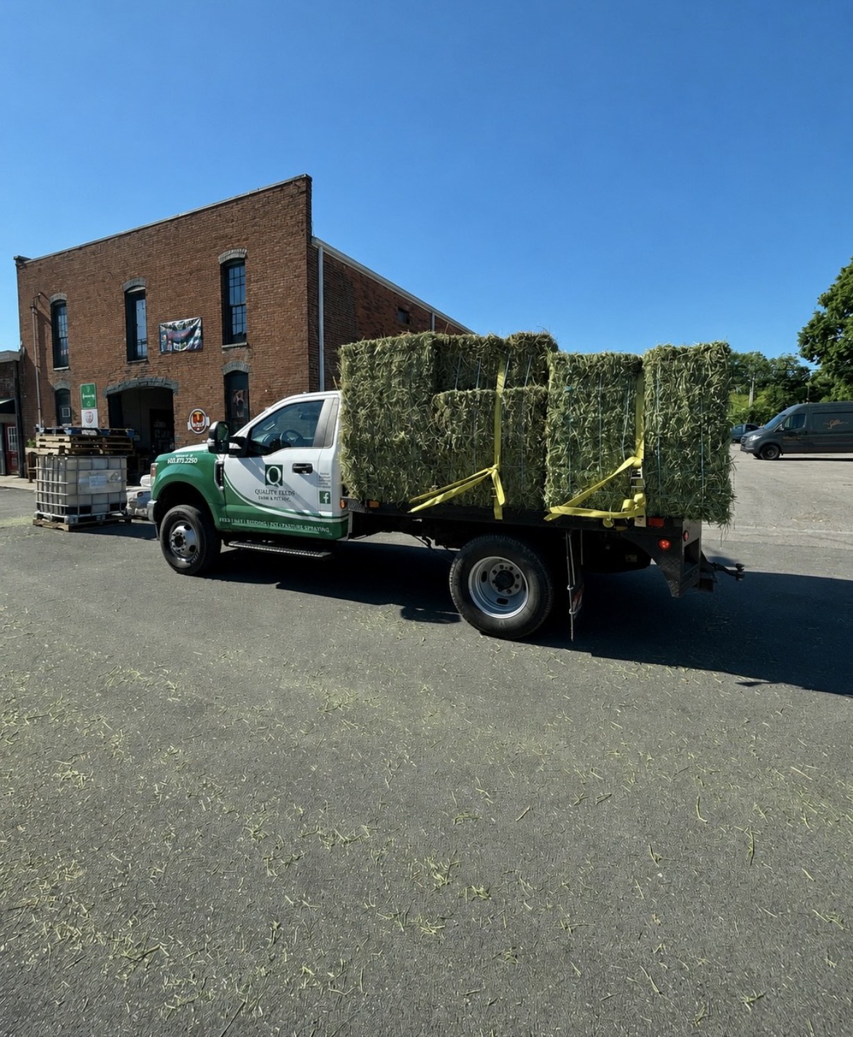 Quality Feeds delivery truck loaded with hay