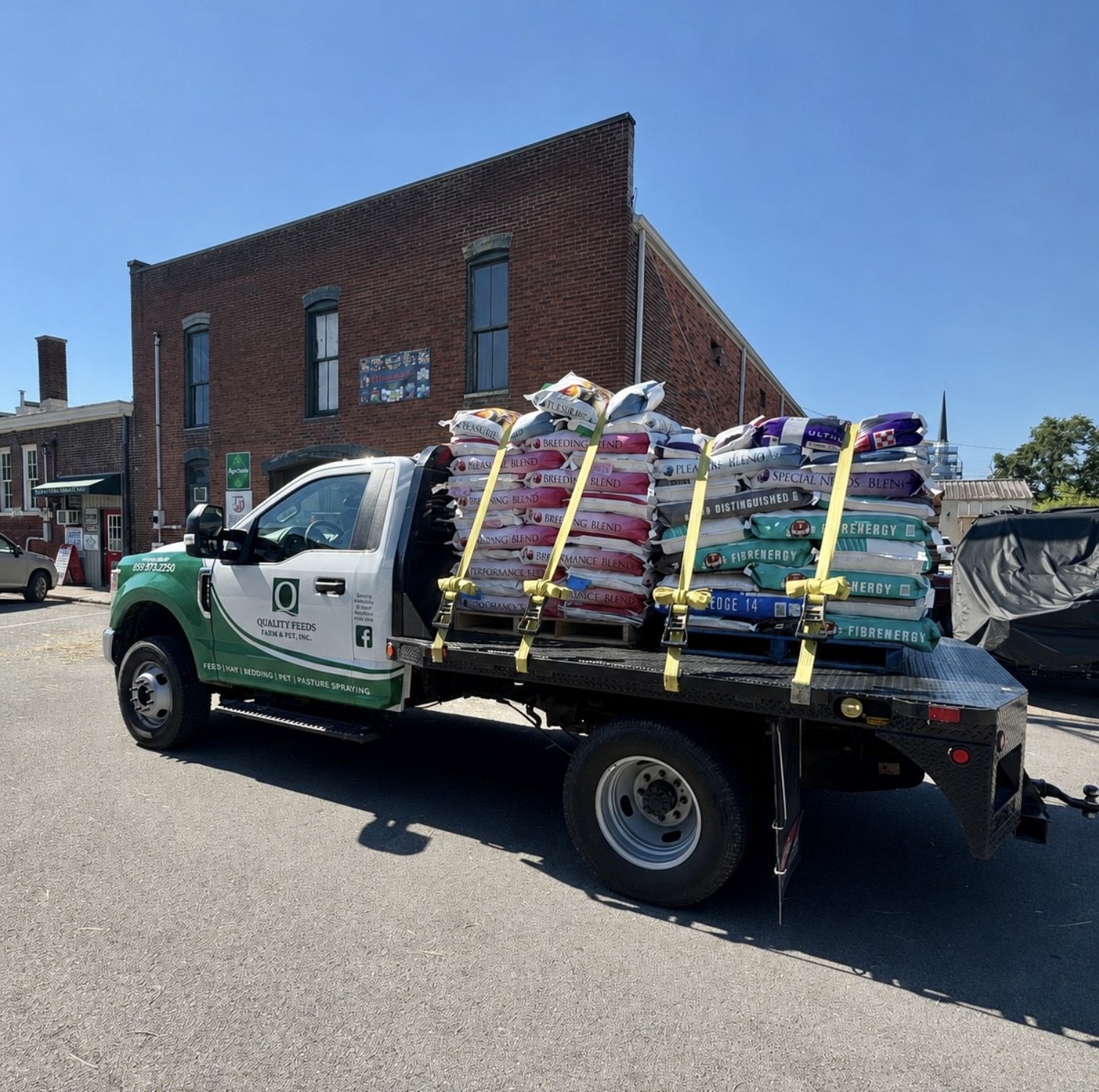 Quality Feeds delivery truck loaded with hay