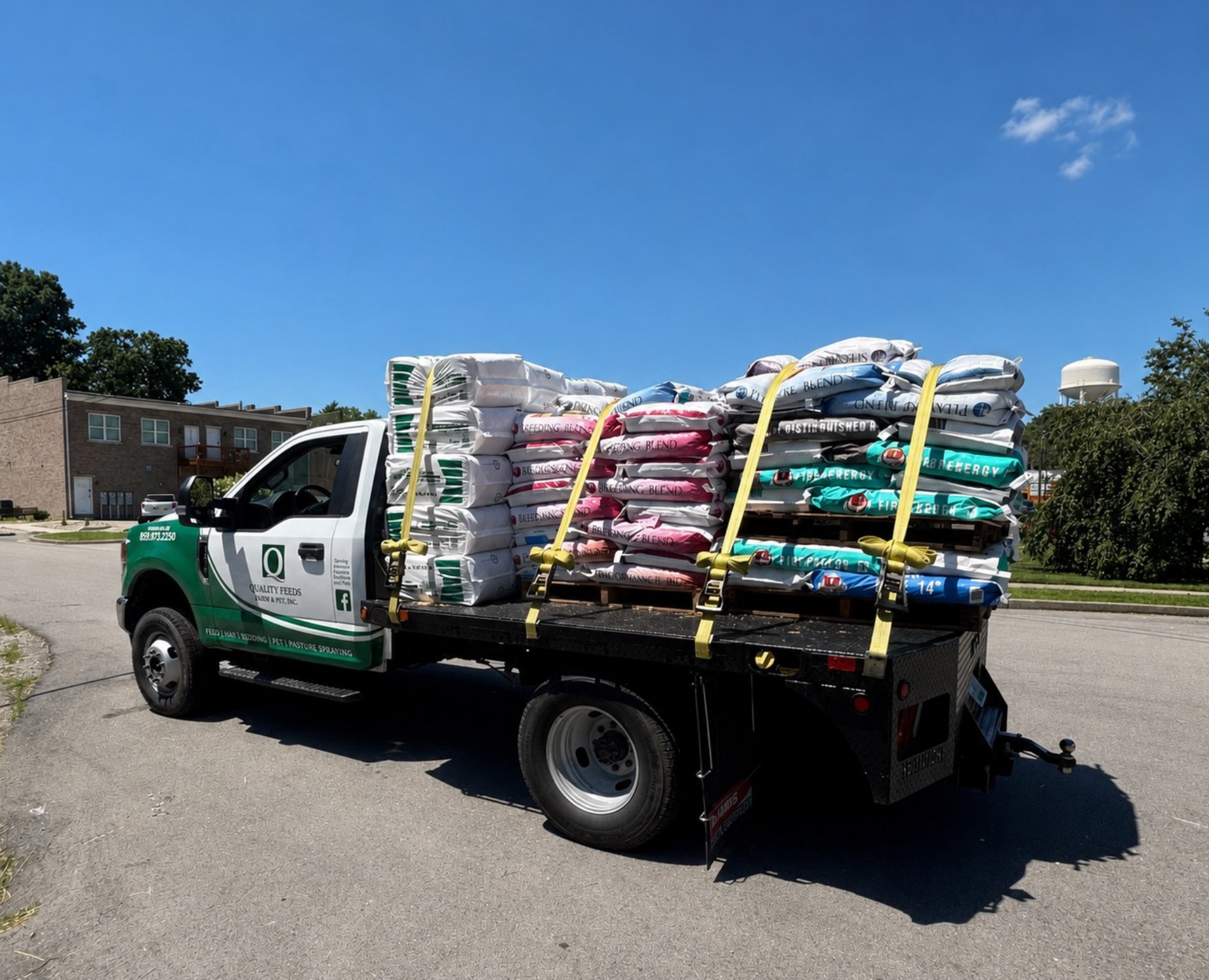 Quality Feeds delivery truck loaded with hay